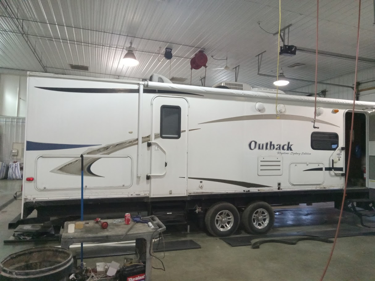 Outback RV exterior metal repair in shop